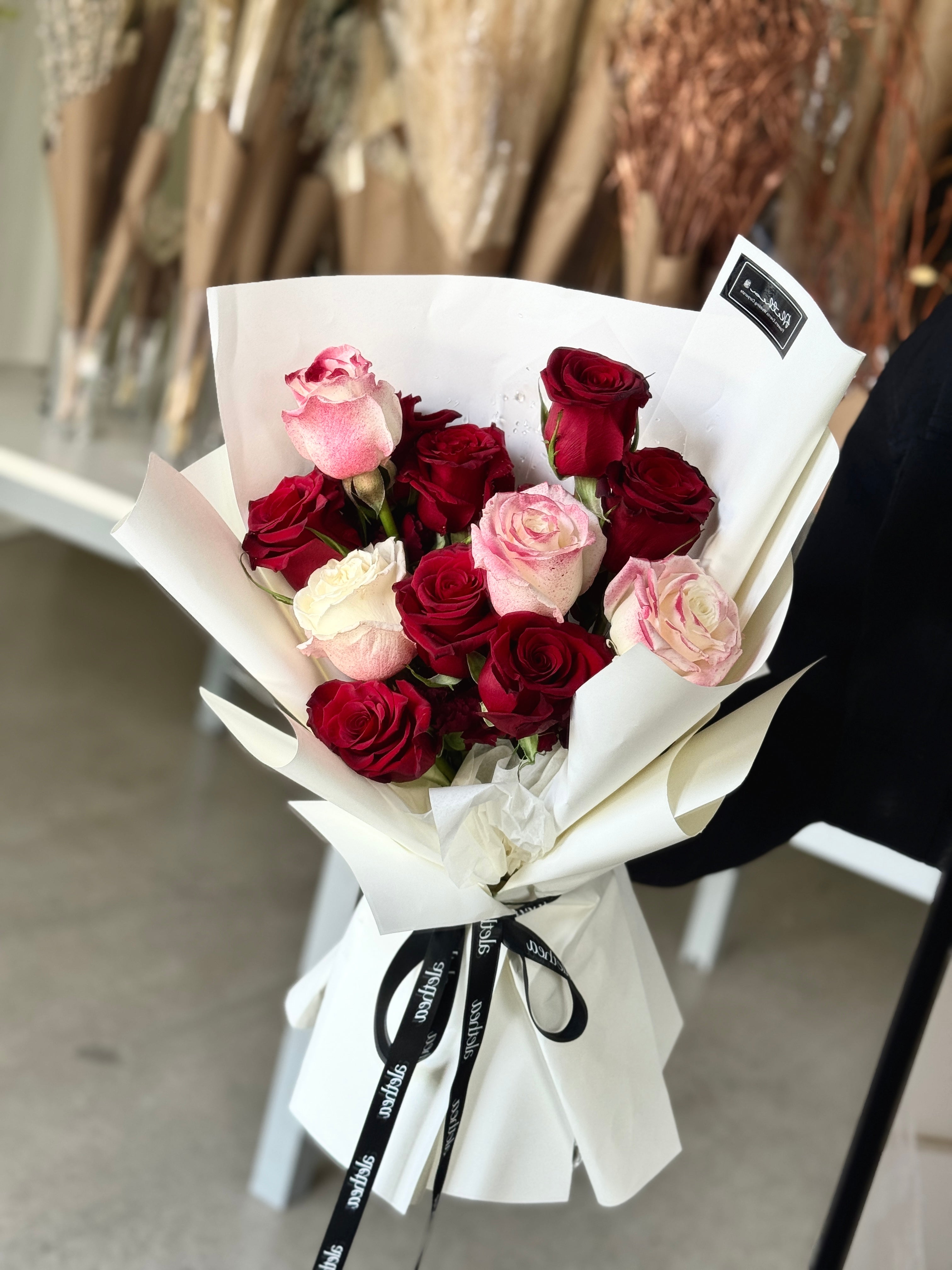 Dozen of mixed red roses bouquet