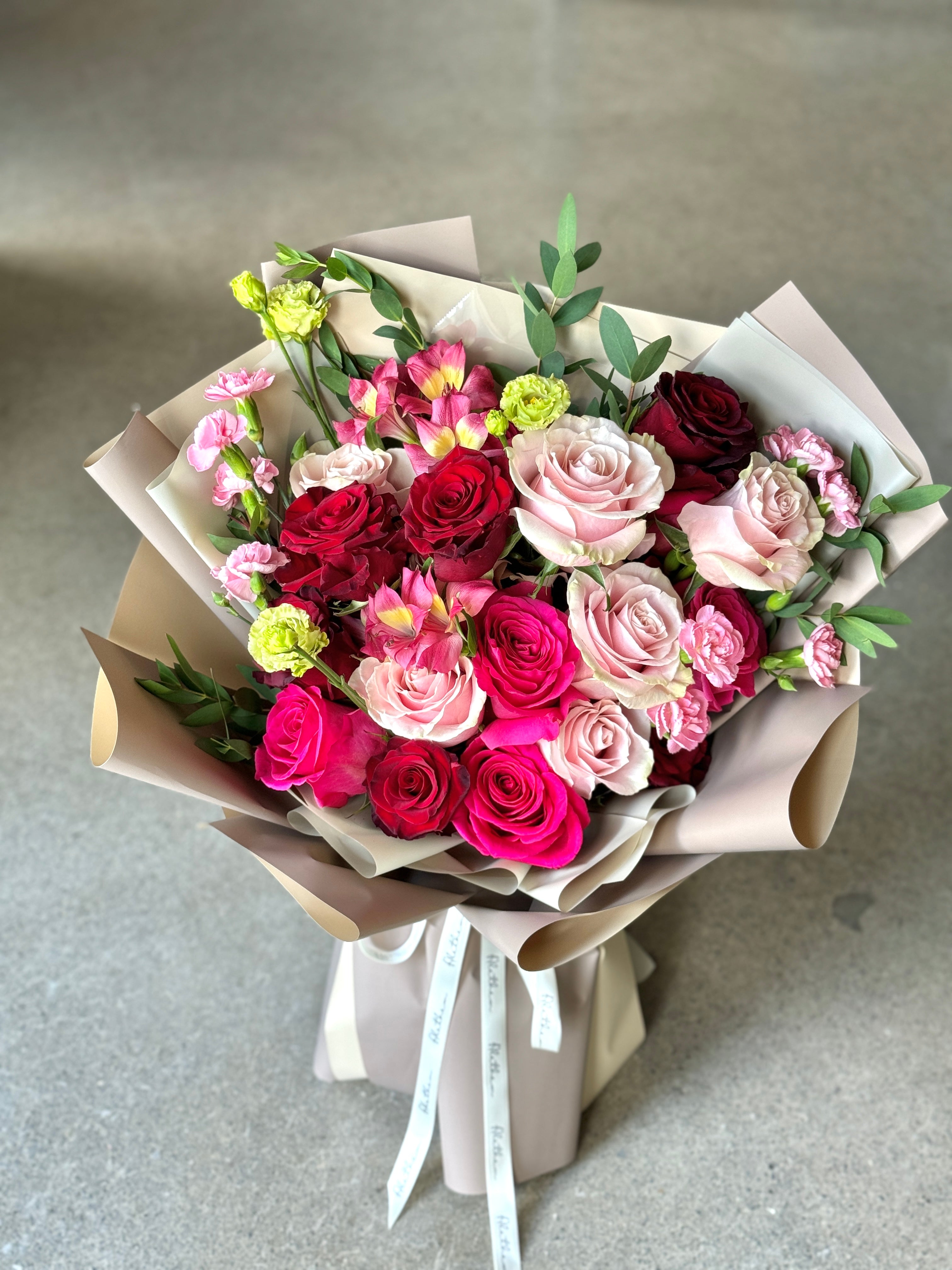 Two dozen mixed red roses bouquet